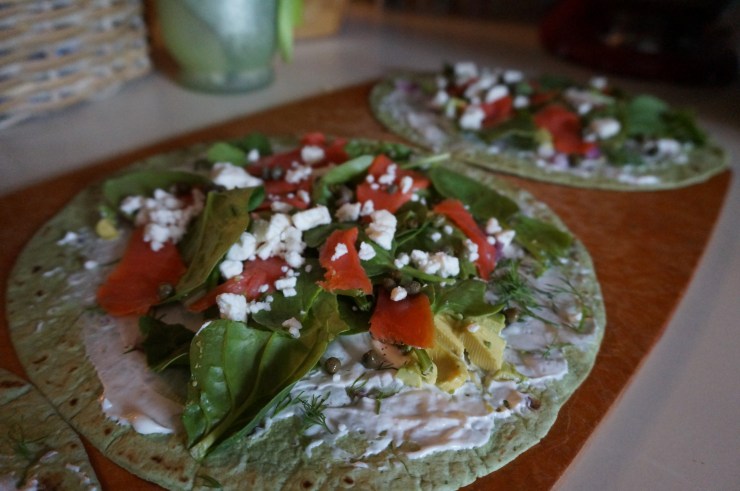 Finish layering with salmon, capers, and feta.