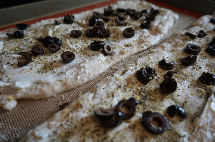 Layer cream cheese, seasonings and olives on dough.