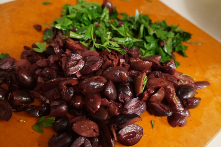 Top with kalamata olives, parsley and capers.