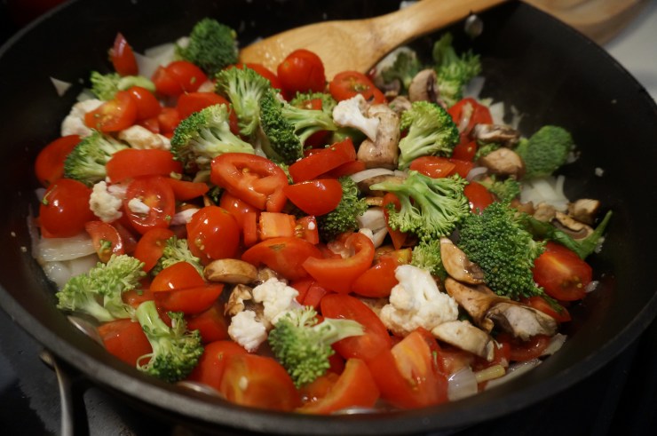 Add veggies to pan and cook, then simmer until squash is done.