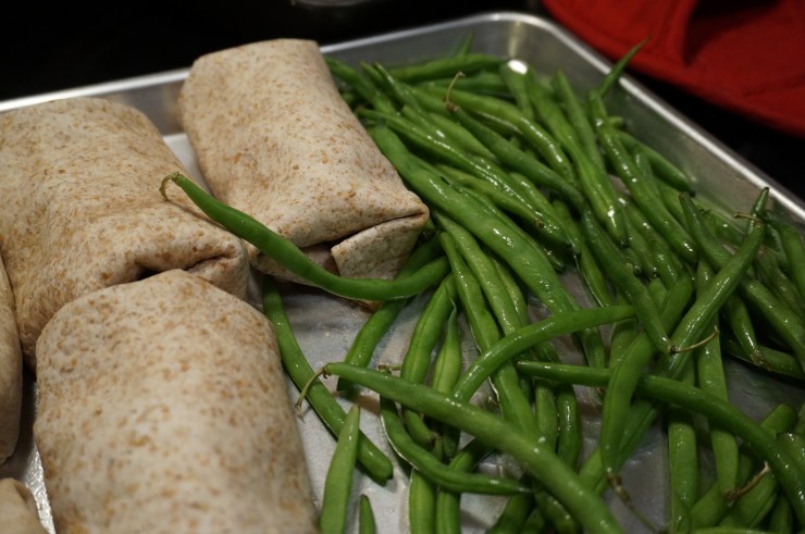 Place on hot baking sheet with green beans.